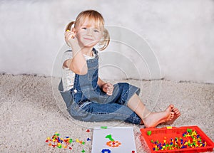 Little girl kid playing with education mosaic pins