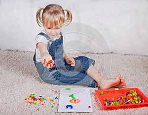 Little girl kid playing with education mosaic pins