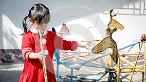 Little Girl kid wearing Santa Claus uniform in the playground, Kid having fun on Christmas holiday time