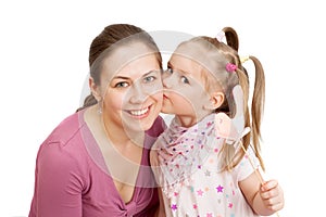 A little girl is kissing a happy mom