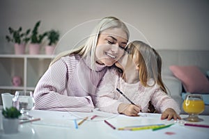 Little girl kissing her mother.