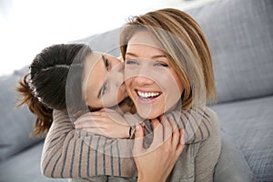 Little girl kissing her mother in cheek