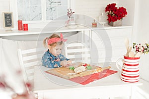 Little girl in the kitchen making cookies