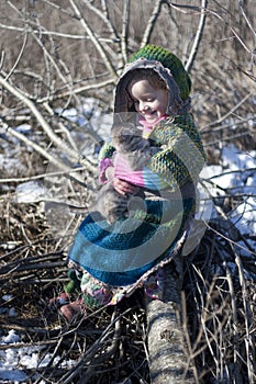 Little girl with a kitten in her arms