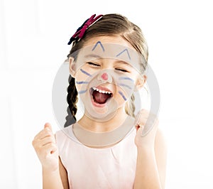 Little girl with kitty painted face