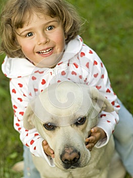 Little girl with Labrador retriever
