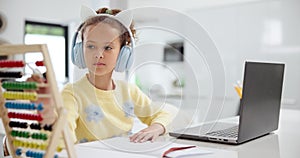 Little girl, laptop and counting on abacus with headphones for mathematics, homework or studying. Young female person