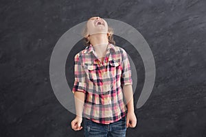 Little girl laughing at grey background