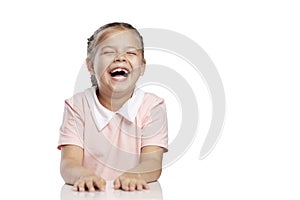 The little girl laughs laughs contagiously. Isolated over white background