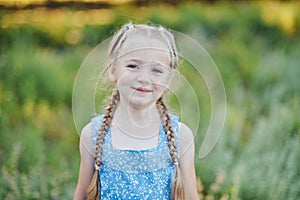 Little girl in lavender field. kids fantasy. Smiling girl sniffing flowers in summer purple lavender field