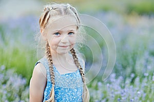 Little girl in lavender field. kids fantasy. Smiling girl sniffing flowers in summer purple lavender field photo