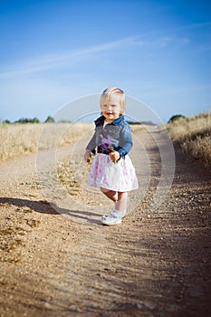 Little girl with lavender flower bouquet