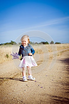 Little girl with lavender flower bouquet