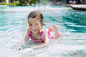 Little girl lay on the pool