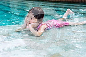 Little girl lay on the pool