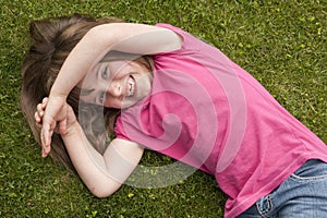 Little girl laying in grass