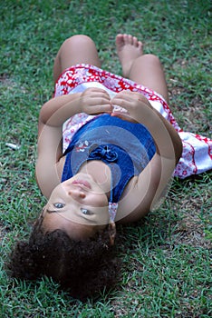 Little Girl Laying In Grass