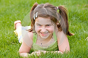 Little Girl Laying in the Grass Laughing