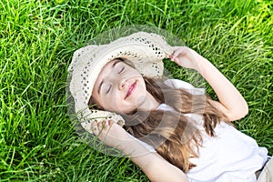 Little girl laying in the grass. summer time and sunny day