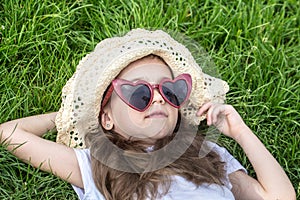 Little girl laying in the grass. summer time and sunny day