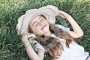 Little girl laying in the grass. summer time and sunny day