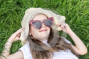 Little girl laying in the grass. summer time and sunny day