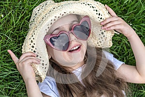 Little girl laying in the grass. summer time and sunny day