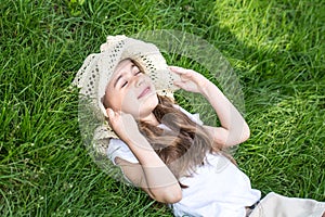 Little girl laying in the grass. summer time and sunny day