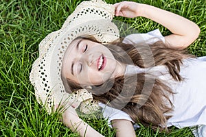 Little girl laying in the grass. summer time and sunny day