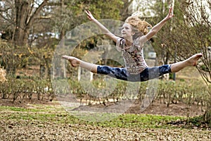 Little Girl Leaping In The Park