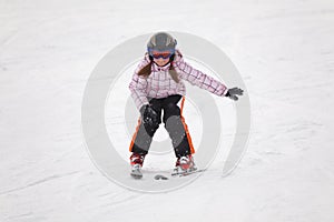 Little girl learning alpine skiing