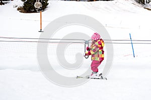 Little girl is learning to ski in ski resort.