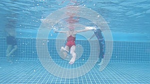 Little girl learning to swim under water shot