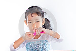 Little girl is learning to use colorful play dough