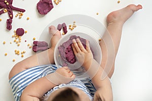 Little girl is learning to use colorful play dough in a well lit room.