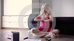 Little girl learning yoga with her teacher