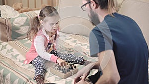 Little girl learns to play chess