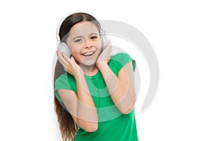 Little girl listen music modern headphones. Small kid listen music headphones. No ad interruptions. Play any song. Try
