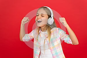 Little girl listen song headphones. Online radio station channel. Girl child listen music modern headphones. Get music