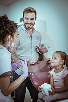 Little girl listening dentists about hygiene mouth.