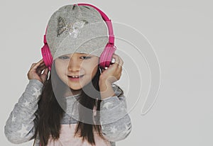 Little Girl Listening Music Headphone Concept photo