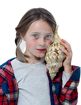 Little girl listening a shell