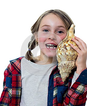 Little girl listening a shell