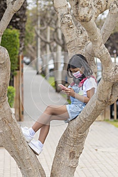 Little girl is listening to music with her headphones