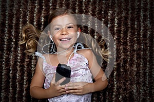 Little girl listening to music on an MP3 player