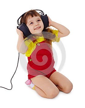 Little girl listens to music