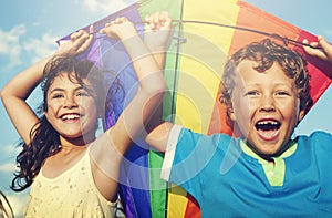 Little Girl And Little Boy Playing Kite Together Concept