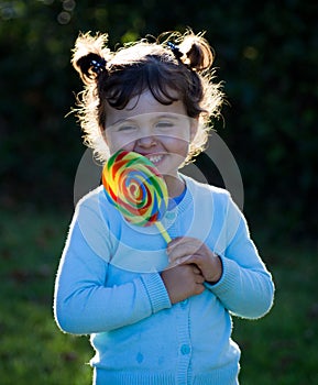 Little girl with lollipop candy