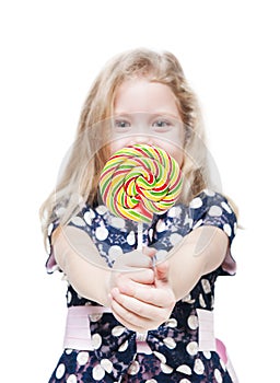 Little girl with lollipop isolated. Focus on candy