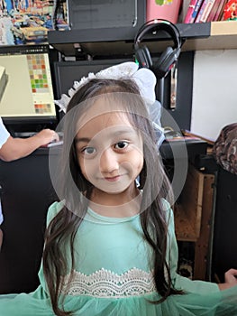 Little girl with long hair and green minty dress.